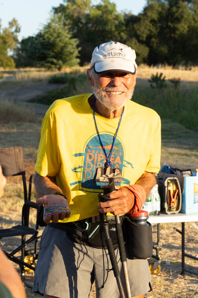 runner posing with medal