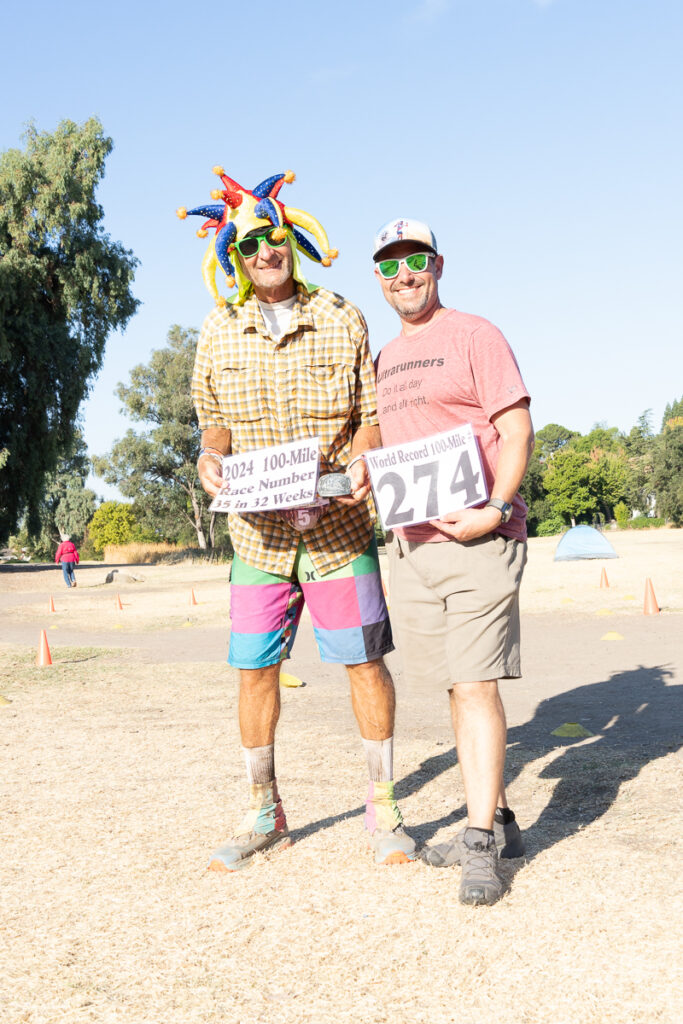 two runners holding award